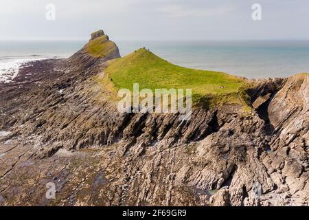 Aerial view of a spectacular rocky coastline and archway at low tide (Worm's Head, Wales) Stock Photo