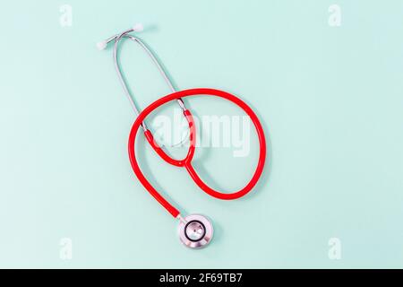 Top view of green stethoscope on wooden background. Medical examination ...