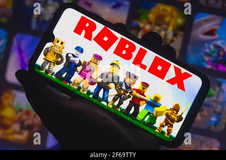 In this photo illustration, the Roblox app seen displayed on a smartphone  screen and a Roblox logo in the background. (Photo by Thiago Prudencio /  SOPA Images/Sipa USA Stock Photo - Alamy