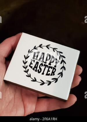 Small Decorative Sign With Words 'Happy Easter', Held in a Hand Stock Photo