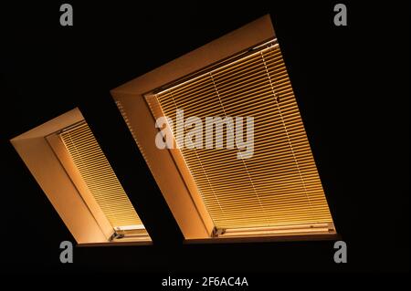 Sloping roof with windows and blinds Stock Photo