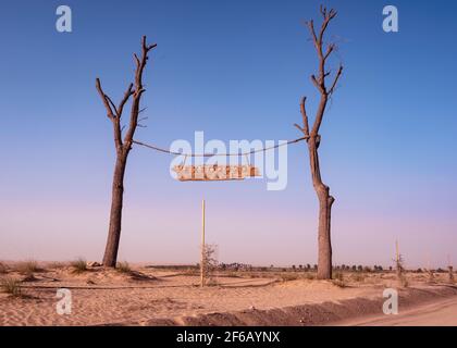 The beautiful entrance banner to the expo 2020 lakes with muddy desert path in the Qudra region at the Expo 2020 lake, Dubai, UAE. Stock Photo