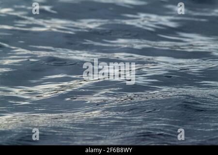 Water, watery swell. Patterns, shapes, created, formed, forming, evolving, from continuous, continuing, upheaval on a moving flowing river surface. Stock Photo