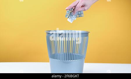 Throw the pills in the trash bin Stock Photo