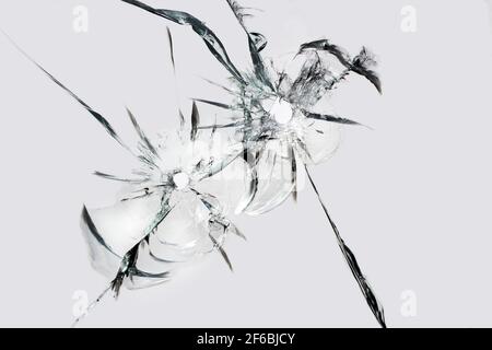Shots on glass. holes with cracks, texture of cracks on broken glass. Stock Photo