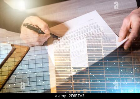 Senior businessman reviewing terms of contract at office; multiple exposure Stock Photo