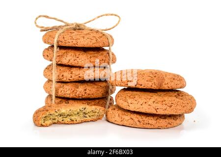 Homemade cookies. Five sweet cookie made from oatmeal flour, stacked and tied with jute rope and three and hakf next. Tasty biscuit close-up isolated Stock Photo