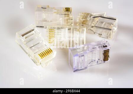 Connector rj-45. Five transparent connectors rj45 for network and internet. Close up macro on gloss white background with shadow. Stock Photo