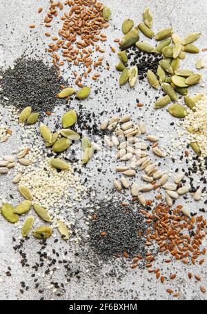 Mix different seeds for a healthy salad on a gray concrete background Stock Photo