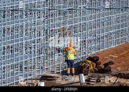 Unrecognizable builder working with metal construction Stock Photo