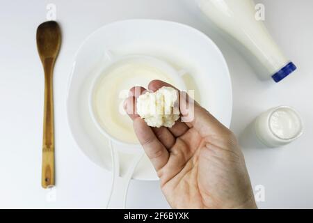 Dairy food concept, showing to the camera fresh and homemade kefir nodules on white background Stock Photo