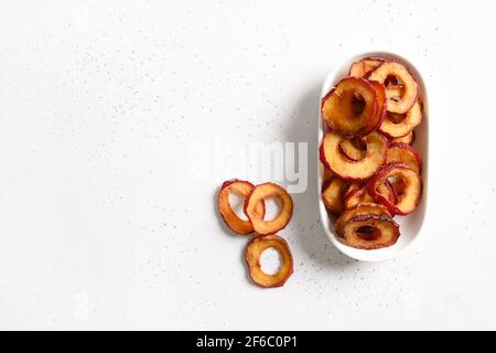 Dried sliced fruits plums in bowl on white background. Copy space. Fall harvest. Home drying. Snack food. Stock Photo