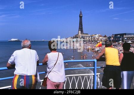 Holidaymakers on Central Pier looking at the beach, North Pier & Tower, Blackpool, Lancashire, England, UK Stock Photo