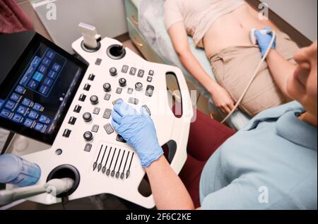 Female patient having ultrasound procedure in medical center. Stock Photo