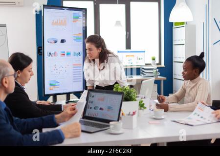 Furious woman screaming at company office boardroom meeting having disagreement controversy. Businesswoman raging about multitasking difficult job, screaming in boardroom Stock Photo