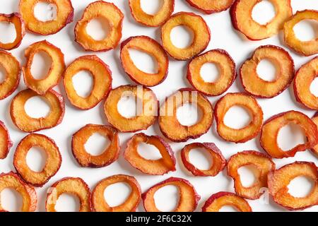 Pattern of plums chips on white background. Fall harvest. Home drying. Snack food. Stock Photo