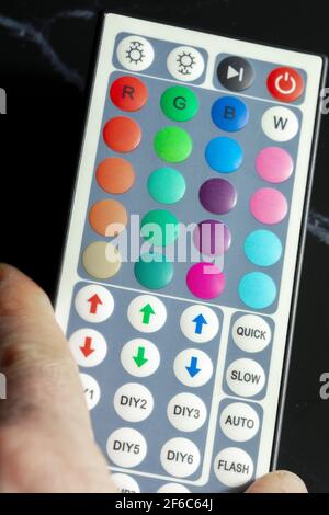 Close-up of remote control to pull colored led light. Stock Photo