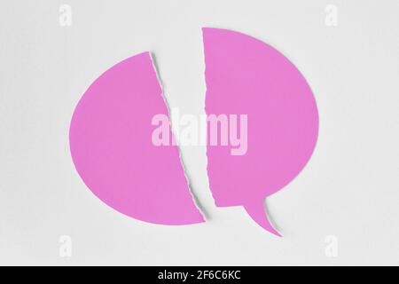 Broken pink speech bubble on white background - Concept of woman and communication problems Stock Photo