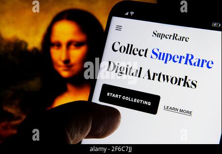 SuperRare Digital artworks website seen on smartphone and Mona Lisa on a blurred background. SuperRare is a NFT Marketplace for Non-Fungible Tokens. C Stock Photo