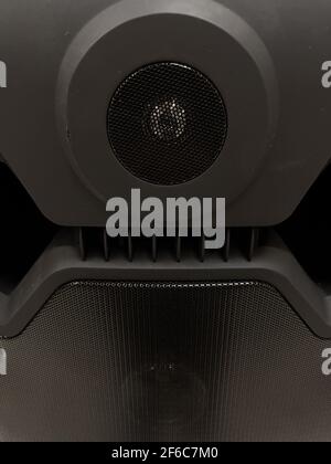 Close-up of musical stereo speaker with protective grill. Modern black audio speaker or music column for background. Stock Photo