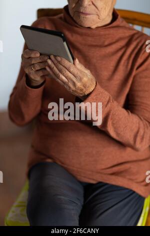 Senior woman using an e book. Selective focus. Stock Photo