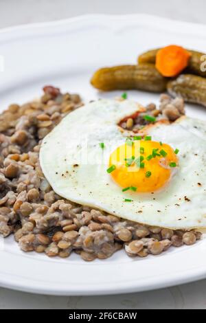 lentils with fried egg and pickled vegetables Stock Photo