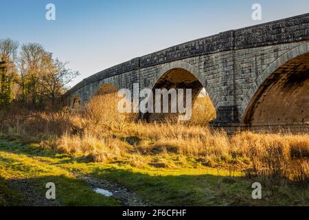 Track beside the arched Ken Bridge at New Galloway, Scotland Stock Photo