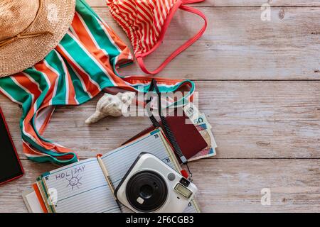 Travel concept banner flat lay.Items for summer vacation: passport,swimsuit,hat,money,diary, camera,diary page copy space.Top view holiday concept Stock Photo