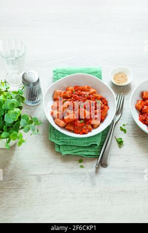 Gnocchi with tomato sauce and seitan ragù Stock Photo
