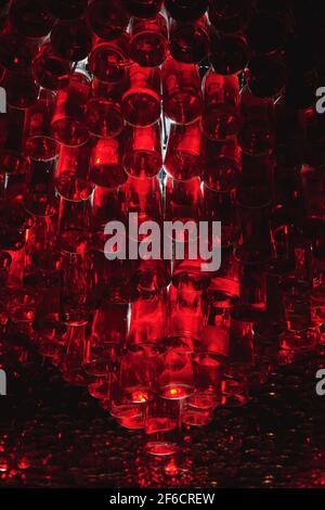 Ceiling of bar made from many bottles with red liquid. Atmosphere bar with low light. Alcohol drinks concept photo. Vertical photo. Stock Photo