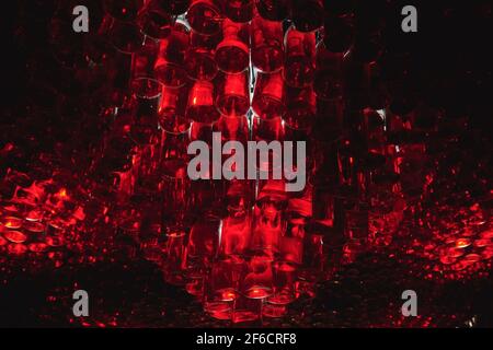 Ceiling of bar made from many bottles with red liquid. Atmosphere bar with low light. Alcohol drinks concept photo. Horizontal photo. Stock Photo