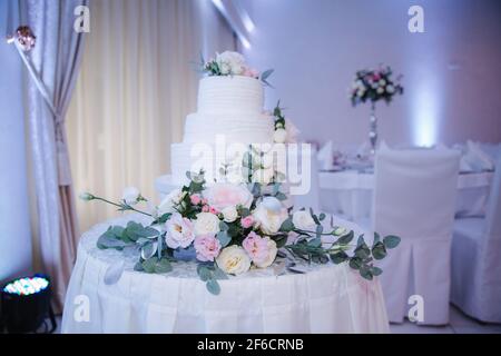 Beautiful wedding cake decorated with flowers Stock Photo