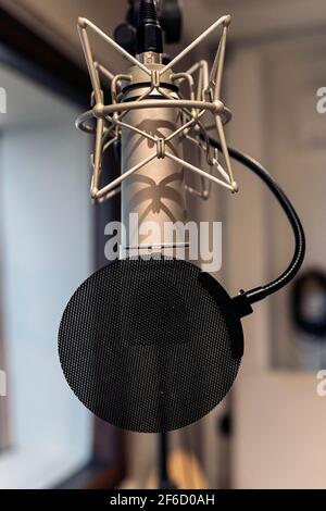 Stock photo of professional microphone in recording room of music studio. Stock Photo