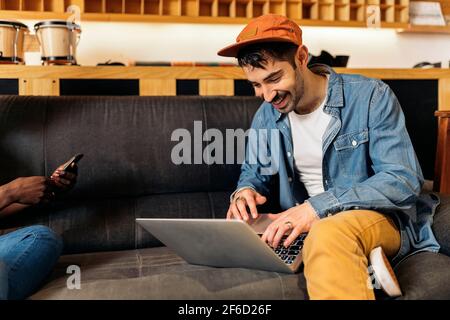Stock photo of music producer using laptop in the music studio. Stock Photo