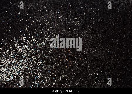 Silver glitter texture on a black background. Holiday background. defocused. Stock Photo