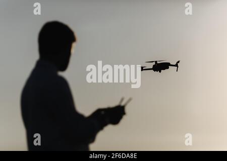 Man with quadcopter at field Stock Photo