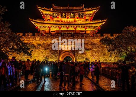 Dali China , 5 October 2020 : Dali old town south gate illuminated at night and crowd of people in Dali Yunnan China Stock Photo
