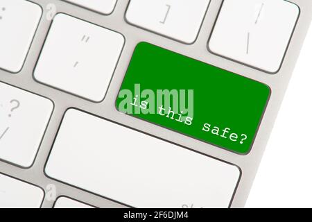 The return button on a computer keyboard colored green, with the question is this safe as a concept for online fraud Stock Photo