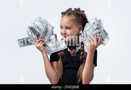 pretty teen girl with pigtails has lots of money isolated on white, dollar Stock Photo