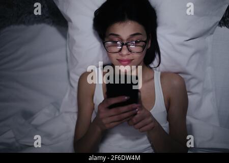 Woman using smartphone at nigh Stock Photo