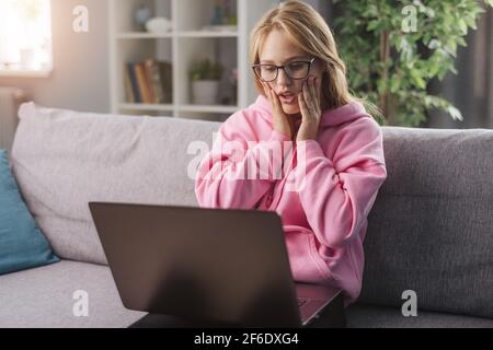 Surprised woman looking at computer Stock Photo
