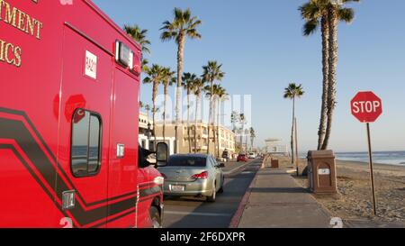 Oceanside, California USA - 11 Feb 2020: EMS emergency medical service red vehicle by ocean beach. Fire department ambulance car. Lifeguard paramedic Stock Photo