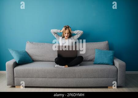 Surprised woman looking at computer Stock Photo