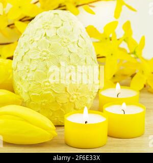 Easter decoration eggs and candles with tulips Stock Photo