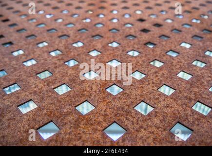 Rusty Texture of Perforated Metal with Regular Pattern of Holes Stock Photo