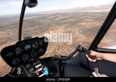 View from inside the Cockpit of an R44 Raven Helicopter, during a scenic flight over Uluṟu-Kata Tjuṯa National Park Stock Photo