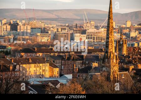 The city of Glasgow with the hills of the Campsie Fells in the background as viewed from the Southside of the city at dawn on a sunny winter morning. Stock Photo