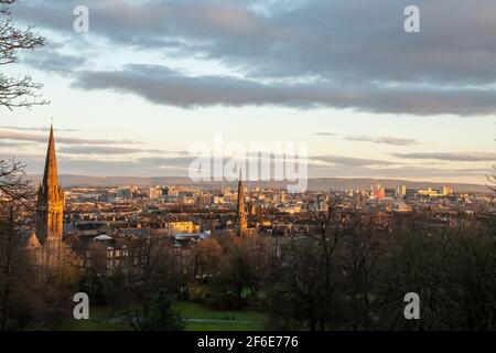 Looking north across the city centre of Glasgow, Scotland towards the Campsie Hills from Queen's Park in the Southside at sunrise on a winter morning. Stock Photo