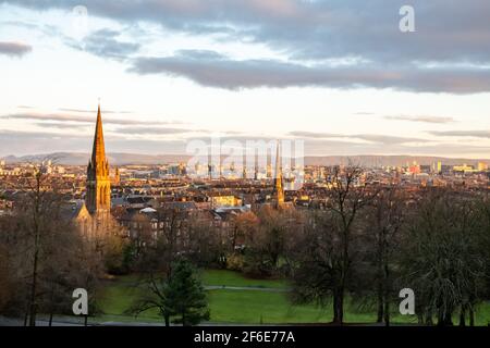 Looking north across the city centre of Glasgow, Scotland towards the Campsie Hills from Queen's Park in the Southside at sunrise on a winter morning. Stock Photo