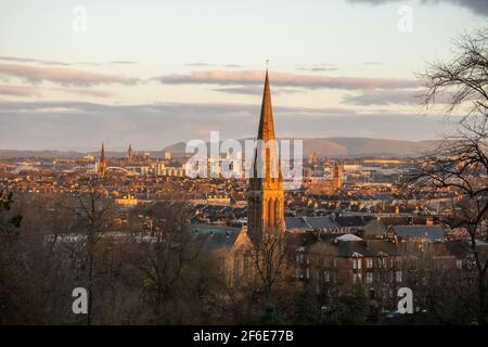 Looking north across the city centre of Glasgow, Scotland towards the Campsie Hills from Queen's Park in the Southside at sunrise on a winter morning. Stock Photo